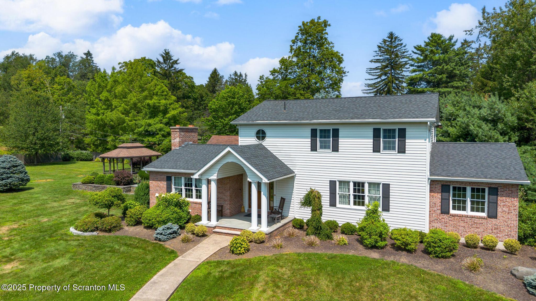 321 North Abington Road Clarks Green, PA 18411 - Photo 2 of 78 a front view of a house with a yard