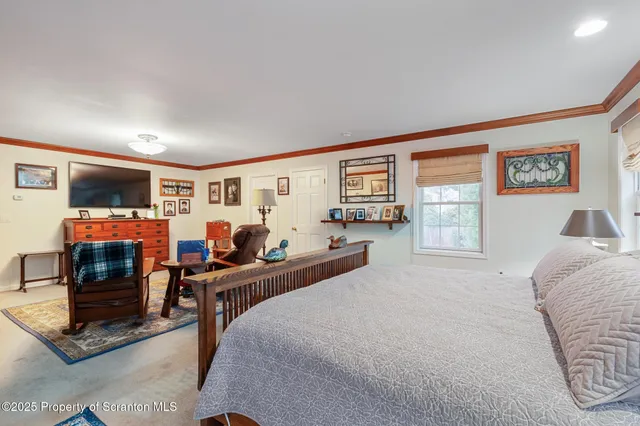 a bedroom with a bed and a lamp on dresser