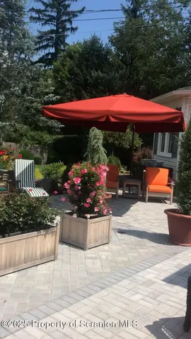 a aerial view of a house with table and chairs and a yard
