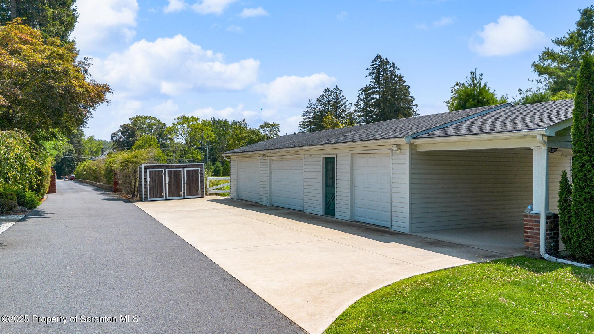 321 North Abington Road Clarks Green, PA 18411 - Photo 59 of 78 a front view of a house with a yard and garage