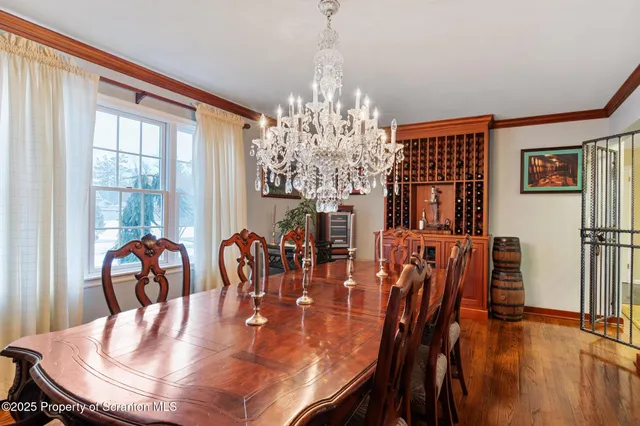 a view of a dining room with furniture wooden floor and chandelier