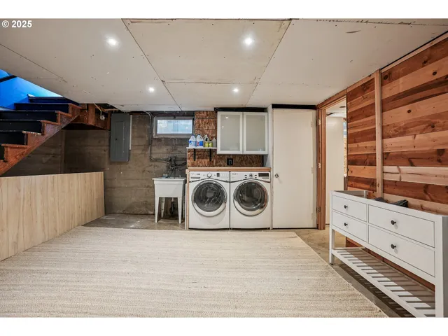 a kitchen with a stove and white cabinets with wooden floor