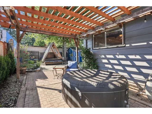 a view of a patio with table and chairs and potted plants