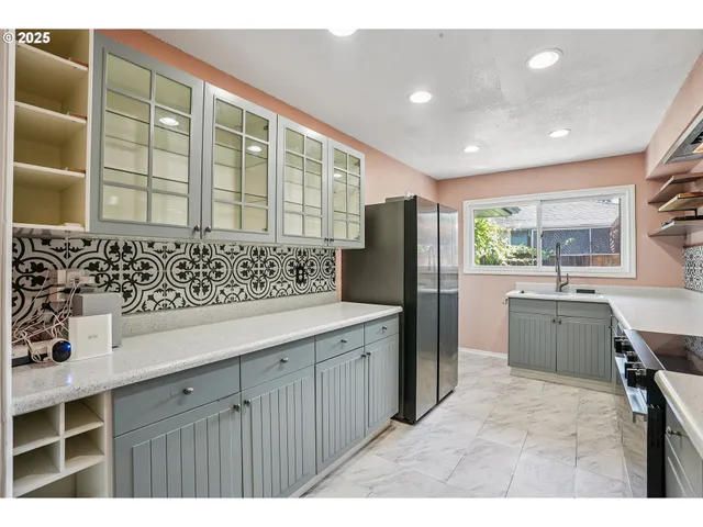 a kitchen with a refrigerator and a sink