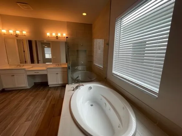a view of an empty room with closet and wooden floor