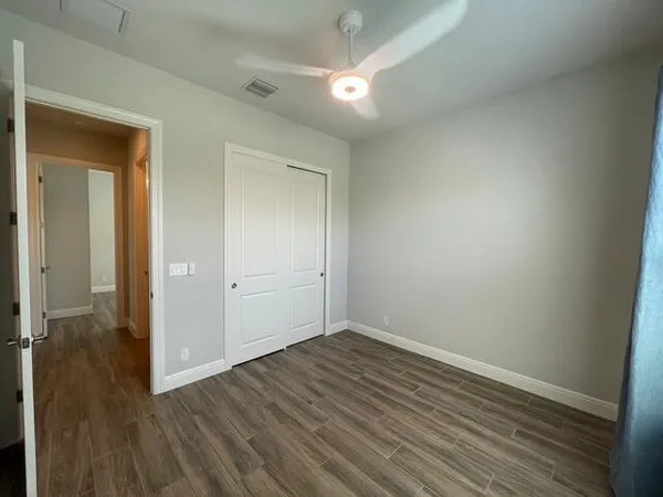 a view of a room with rack on the wall and a window