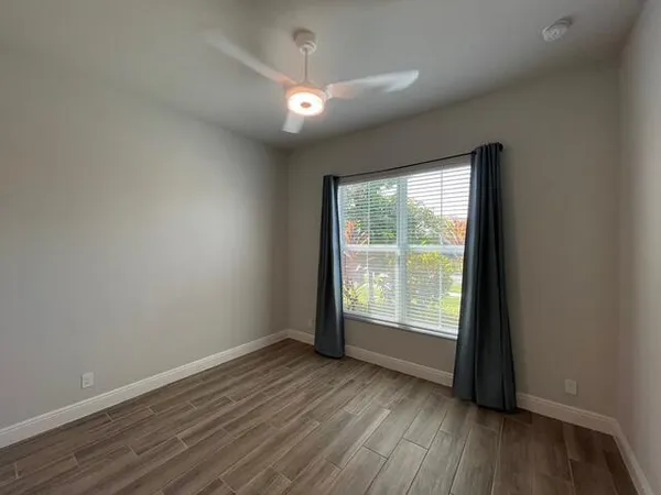 a living room with lots of furniture and a large window