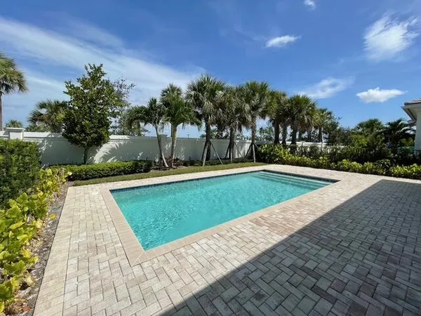 a view of swimming pool with outdoor seating and plants
