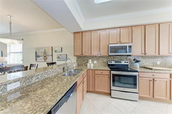 a kitchen with stainless steel appliances granite countertop a stove oven and a sink