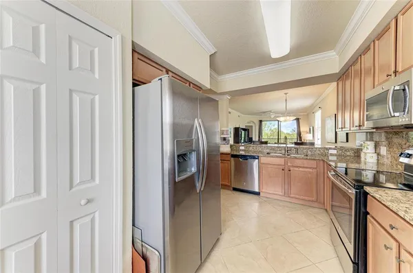 a kitchen with stainless steel appliances granite countertop a refrigerator and a sink