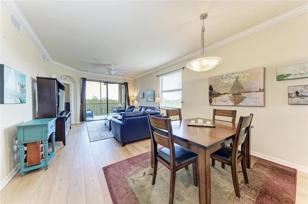 a view of a dining room with furniture window and wooden floor