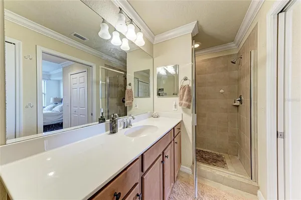 a bathroom with a double vanity sink mirror and shower