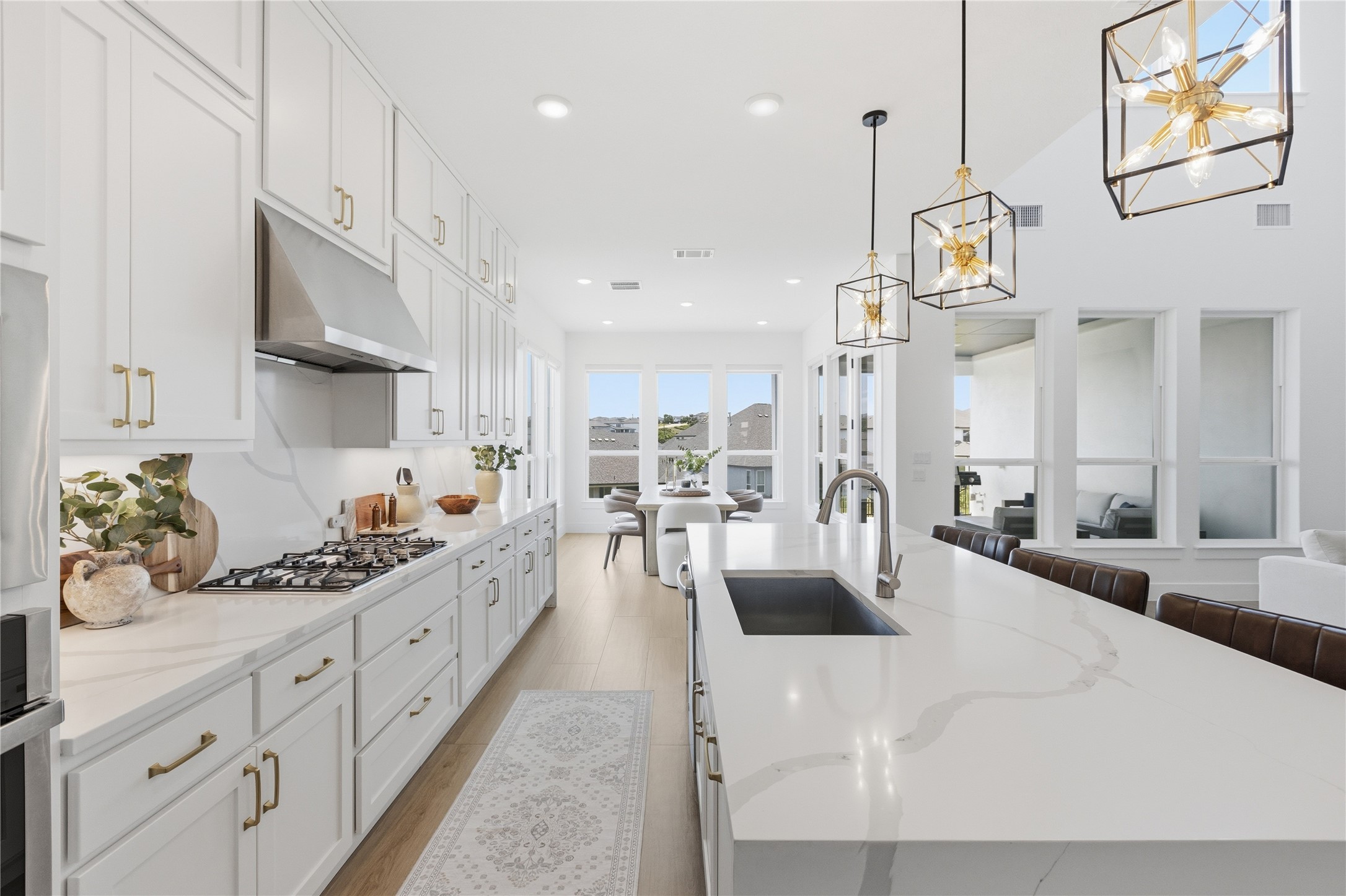 836 Villa Rialto View Leander, TX 78641 - Photo 11 of 33 Culinary delights await in this bright kitchen, boasting an island with a sink and ample counter space.