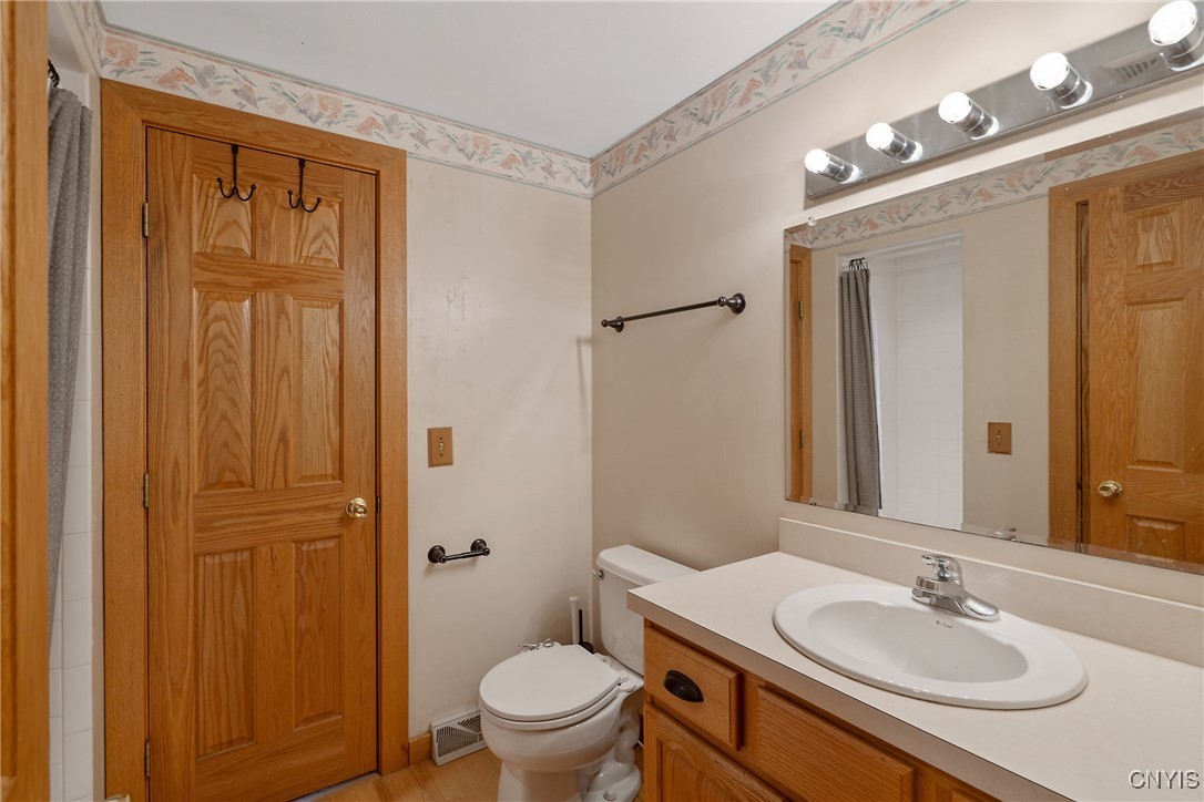 8734 Radburn Drive Lysander, NY 13027 - Photo 18 of 40 First floor FULL bathroom has hardwoods, single si