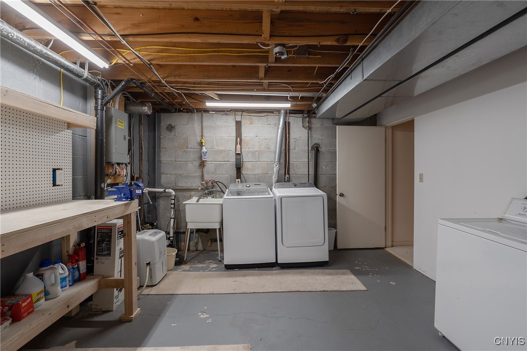 8734 Radburn Drive Lysander, NY 13027 - Photo 32 of 40 Clean and bright laundry room has workbench area,