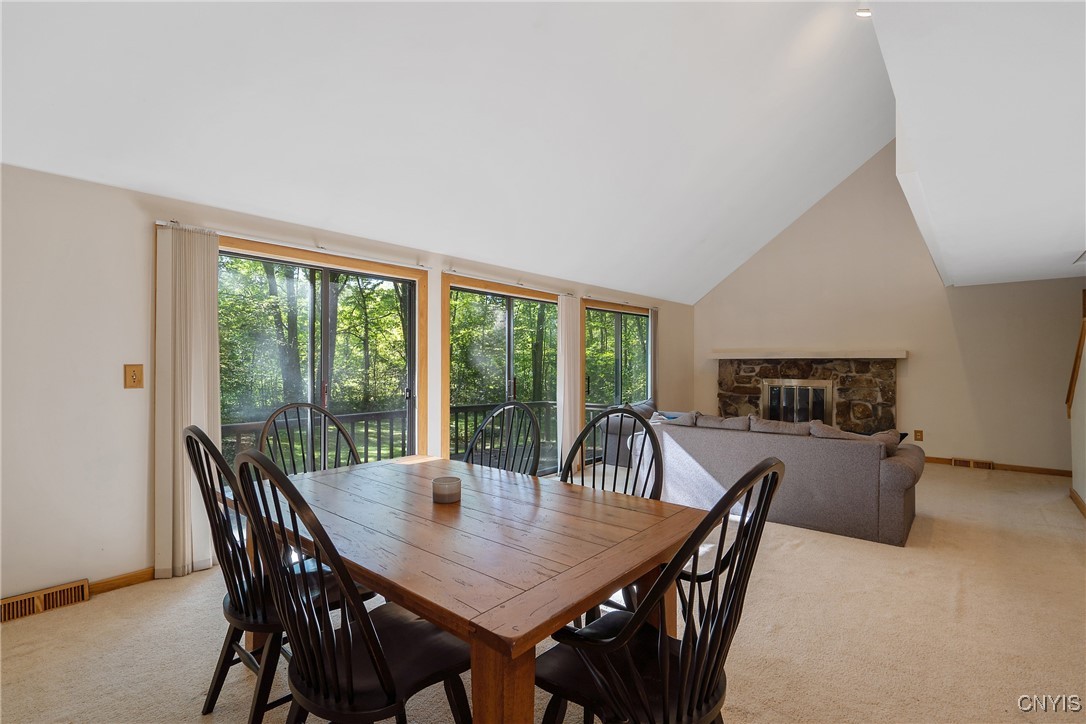 8734 Radburn Drive Lysander, NY 13027 - Photo 5 of 40 Three sliding doors with screens lead to a large d