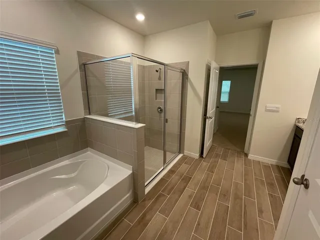 a bathroom with a bathtub and a shower