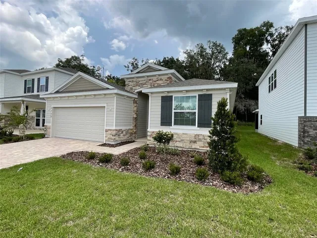 a view of a house with garden and yard