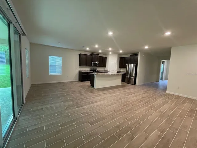 a view of kitchen with refrigerator and window