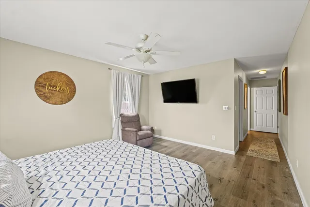 a bedroom with a bed and a flat screen tv