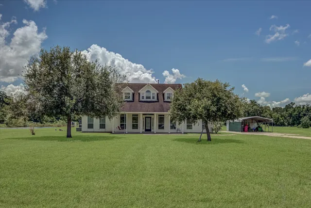 a view of a big building with a big yard and large trees