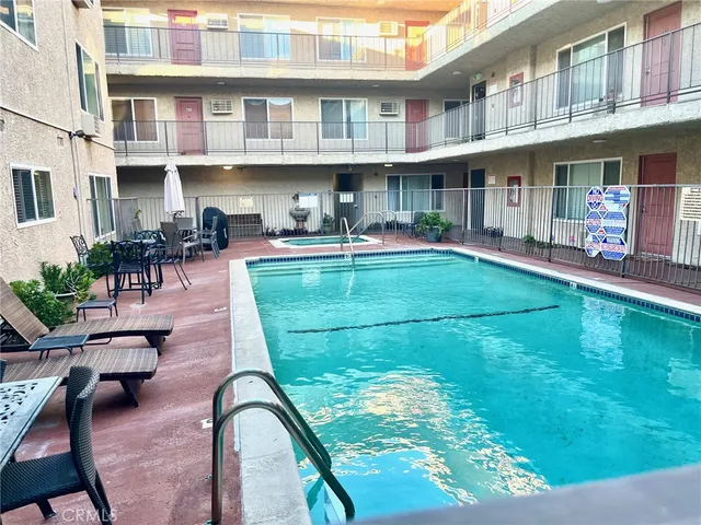 a view of a swimming pool with a patio and a yard