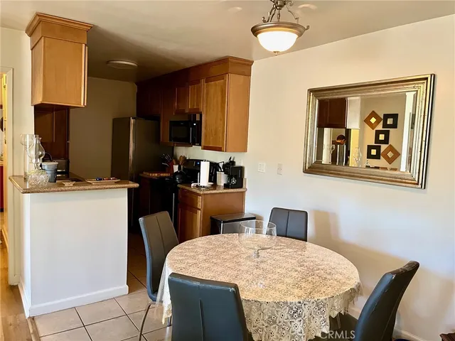 a kitchen with a refrigerator and a stove top oven