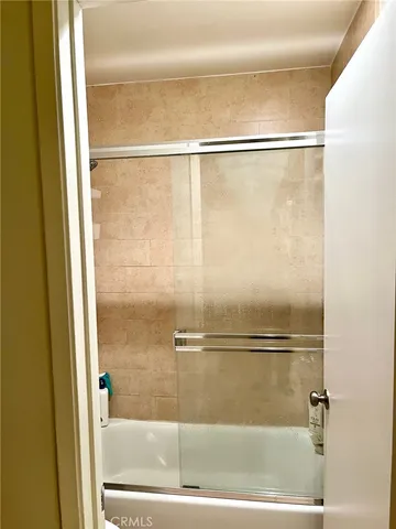 a bathroom with a glass shower door