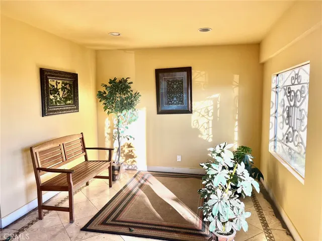 a living room with furniture and flowers
