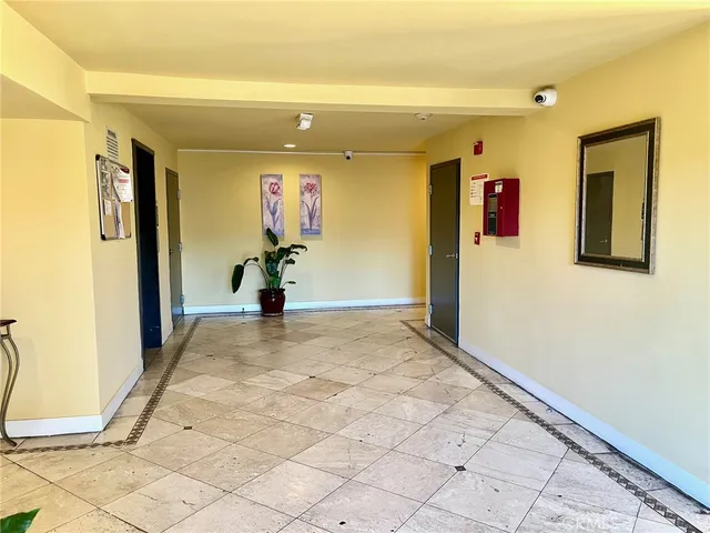 a view of a hallway with wooden floor and closet