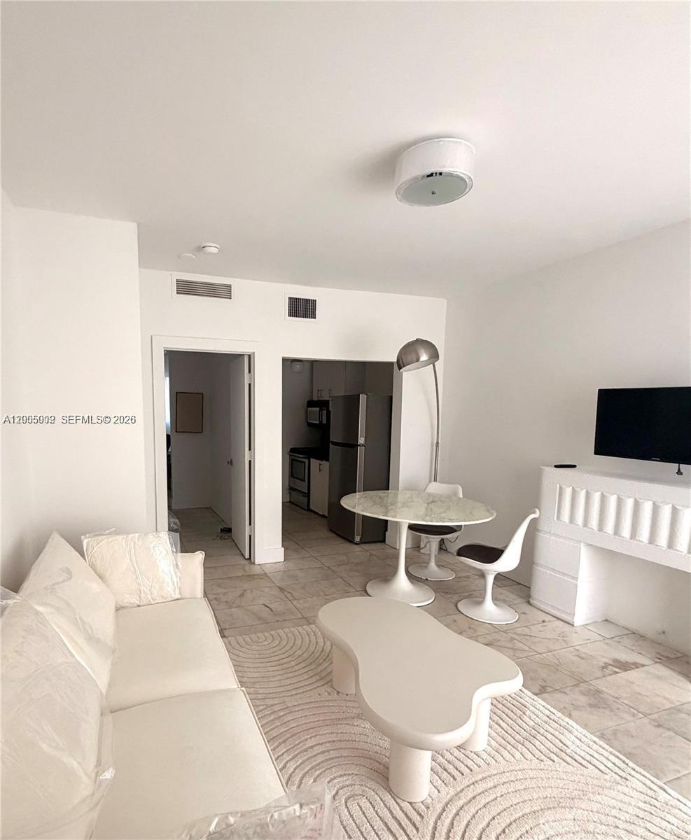 801 8th Street, Unit 104 Miami Beach, FL 33139 - Photo 2 of 8 a bedroom with a bed and wooden floor