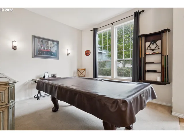 a living room with a table chairs and a window