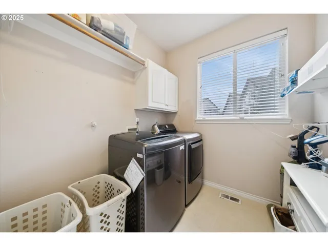 a utility room with closet dryer and washer