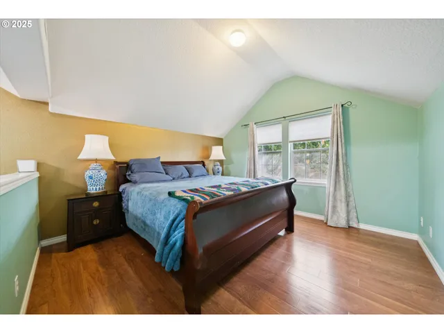 a bed room with a bed and a large window