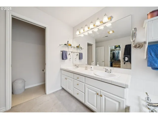 a bathroom with a double vanity sink and a mirror