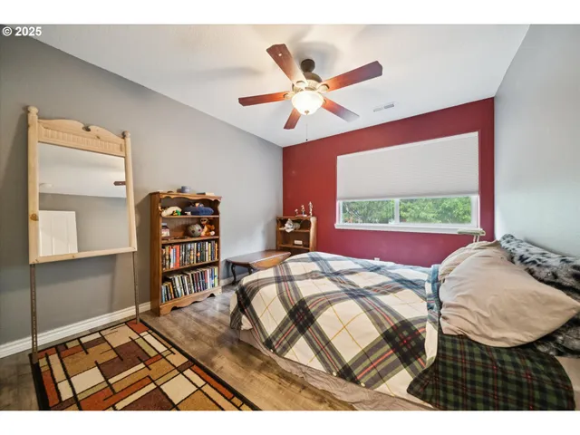 a bed sitting in a bedroom next to a window