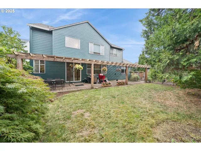 a backyard of a house with yard and outdoor seating