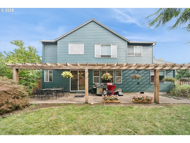 a backyard of a house with table and chairs