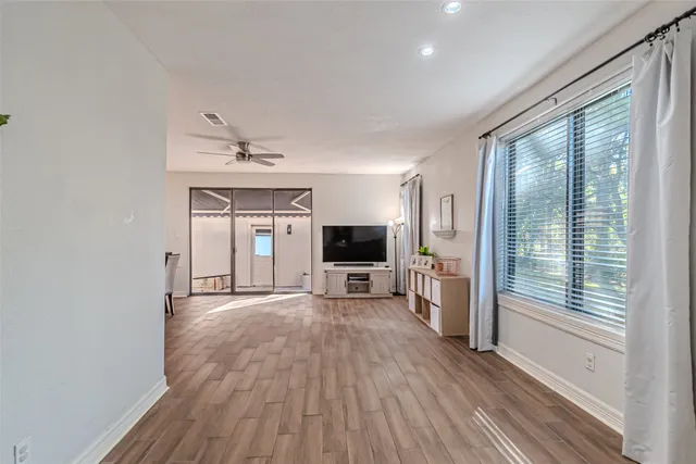 a view of a room with window and wooden floor
