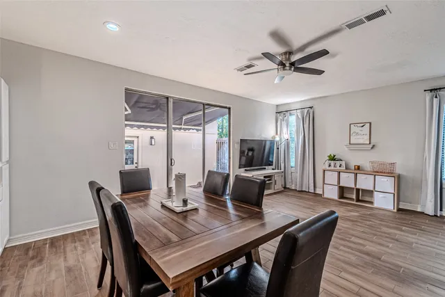 a dining room with furniture window and wooden floor