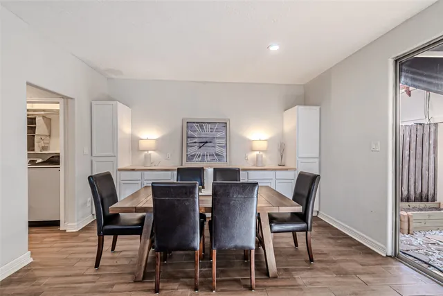 a view of a dining room with furniture and wooden floor