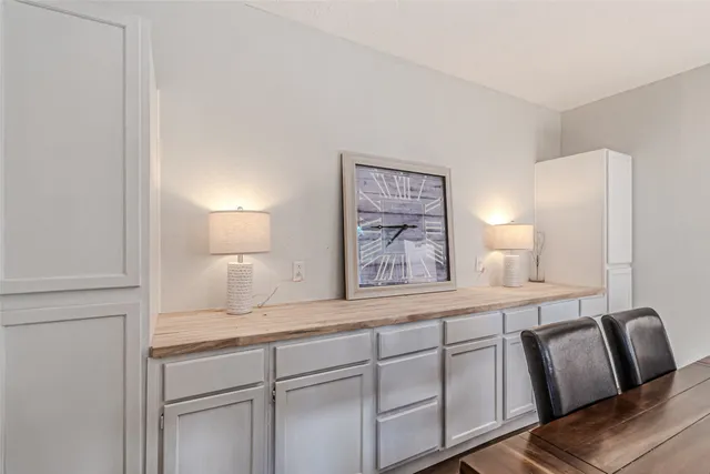 a spacious bathroom with a granite countertop sink and a mirror