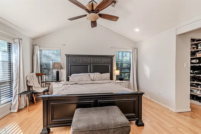 a bed sitting in a bedroom next to a window with pc on the table