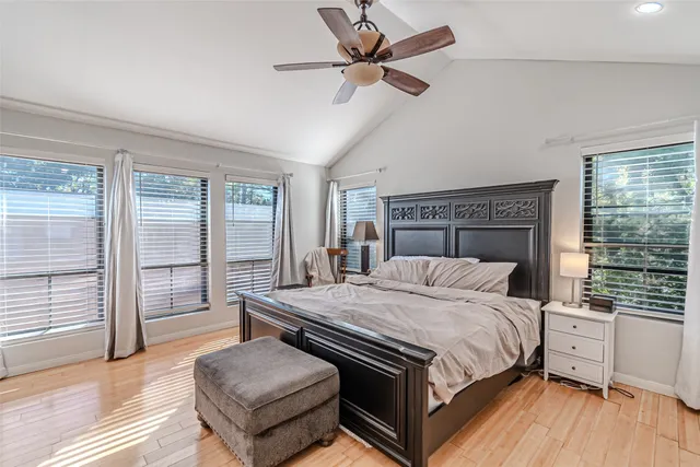 a bedroom with a bed and a large window with balcony view