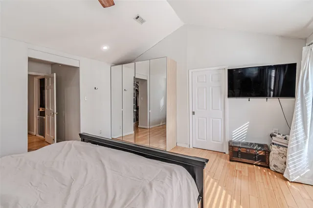 a bedroom with a bed and a flat screen tv