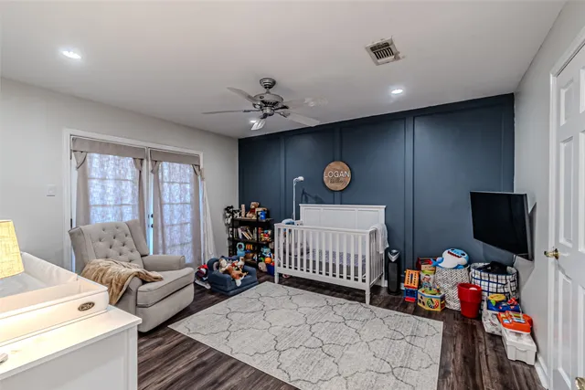 a bedroom with furniture and a flat screen tv