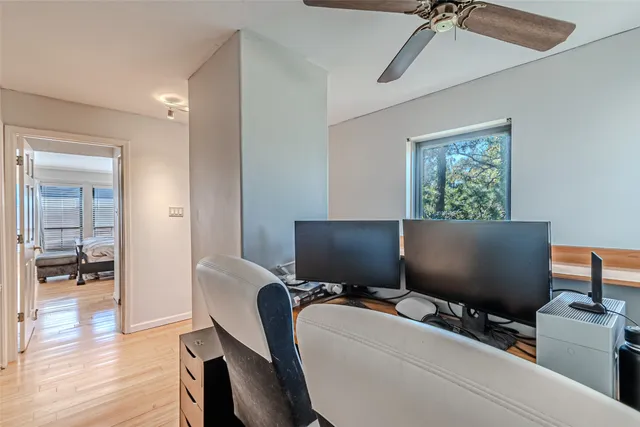 a view of a workspace with furniture and a window
