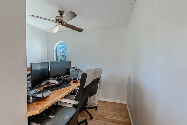 a view of a workspace with furniture and a window