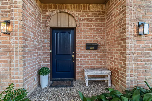 a front view of a house with potted plants