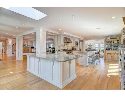 646 South Orleans Road Orleans, MA 02653 - Photo 16 of 42 a living room with stainless steel appliances kitchen island granite countertop a table chairs and a wooden floor